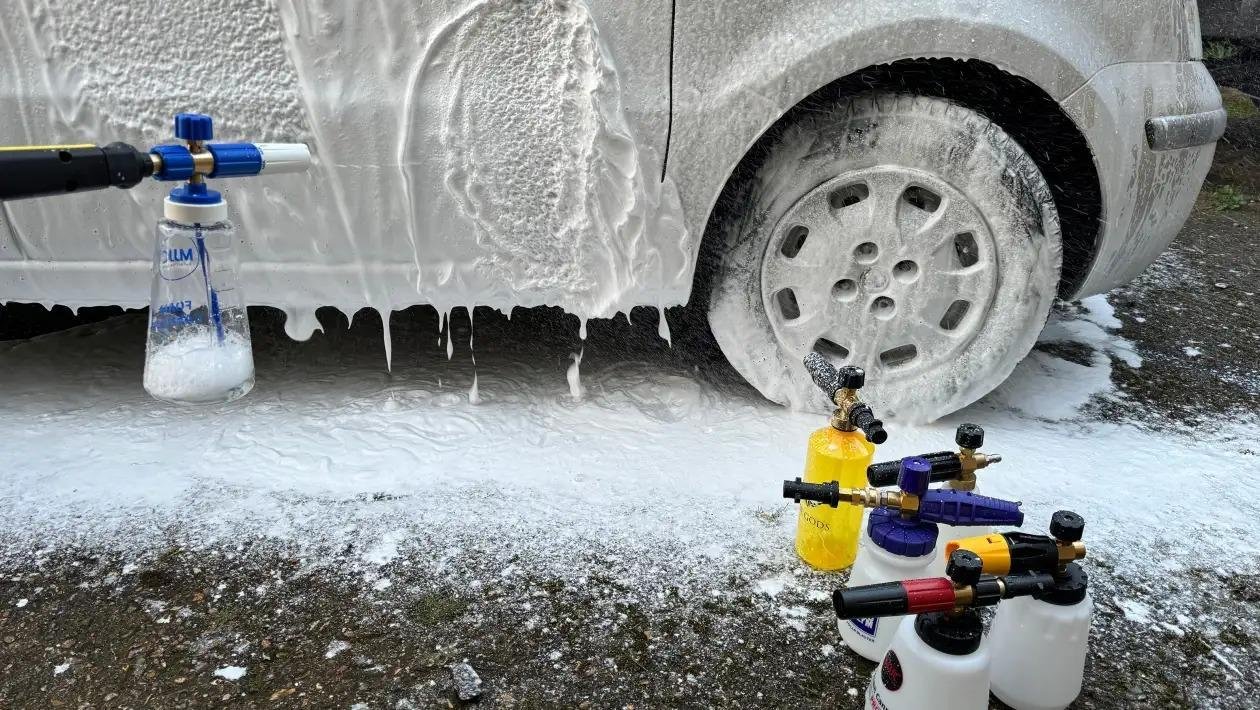 Car wheels being cleaned with foam spray and bottles nearby